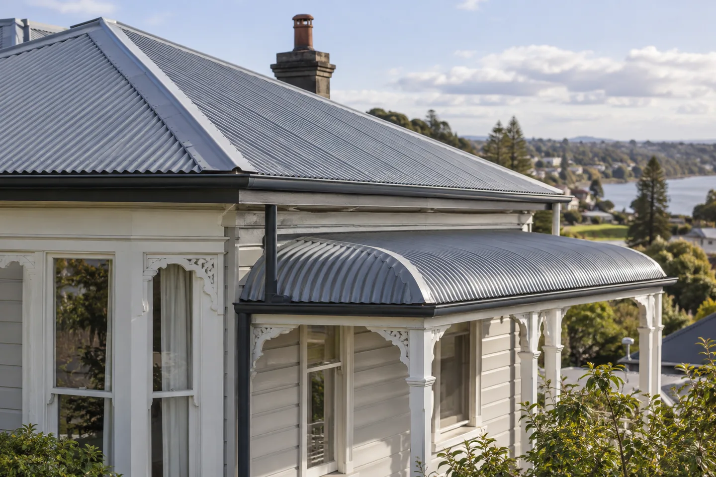 Roofing concept: curved corrugated metal sheets on a classic weatherboard villa