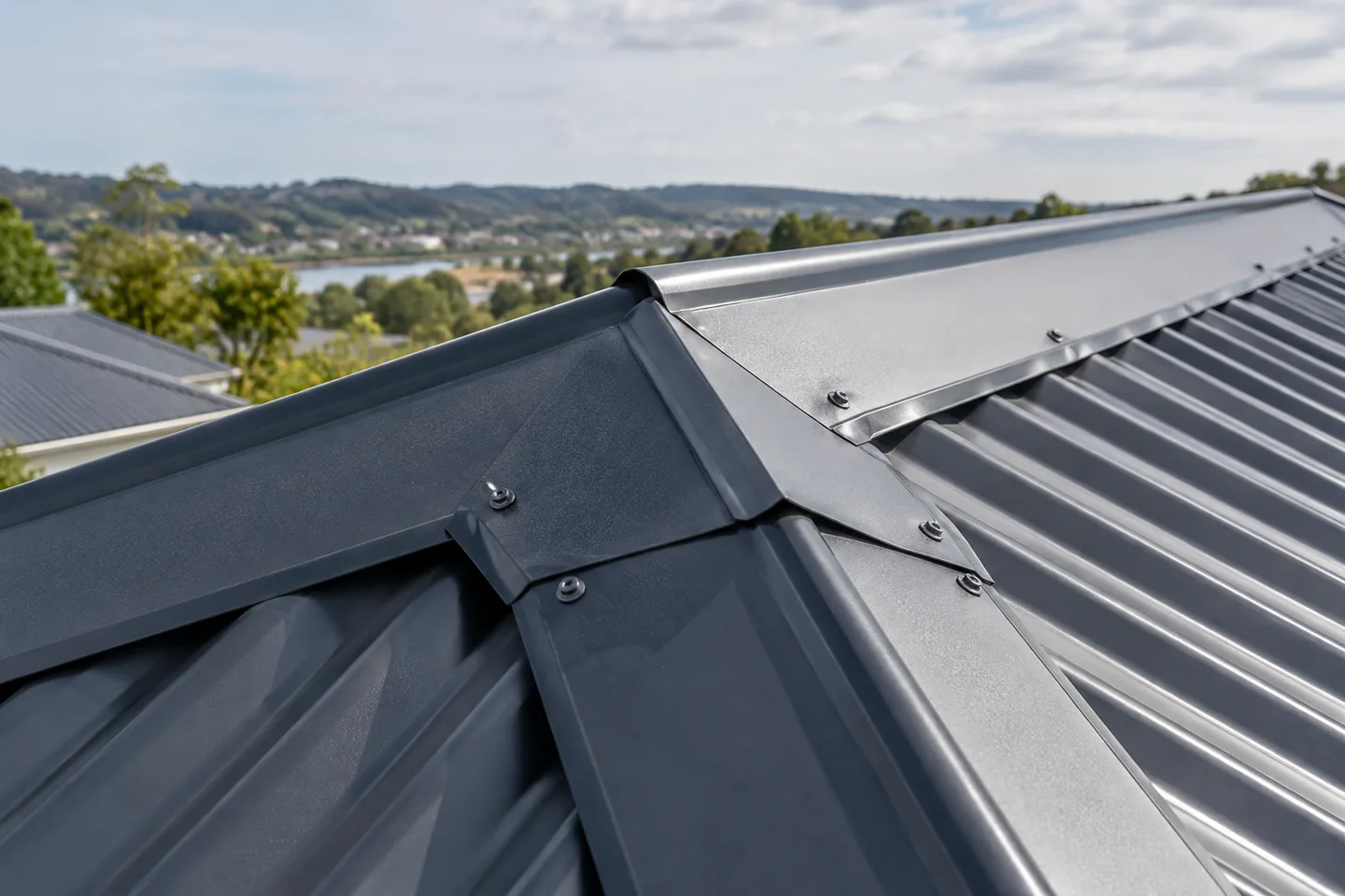 Roofing concept: Close view of a metal ridge cap and adjoining roof sheets